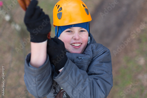 Photo: Smiling little climber passes obstacle Smiling little climber passes obstacle