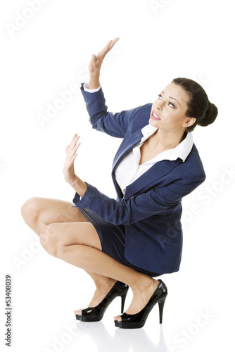 Photo: Scared businesswoman defending herself Scared businesswoman defending herself