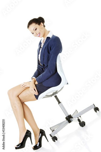 Photo: Beautiful successful businesswoman sitting on ofice chair Beautiful successful businesswoman sitting on ofice chair