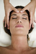 Young woman getting a facial massage