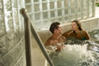 Young couple relaxing in whirlpool in spa