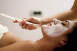 Young woman getting a facial treatment
