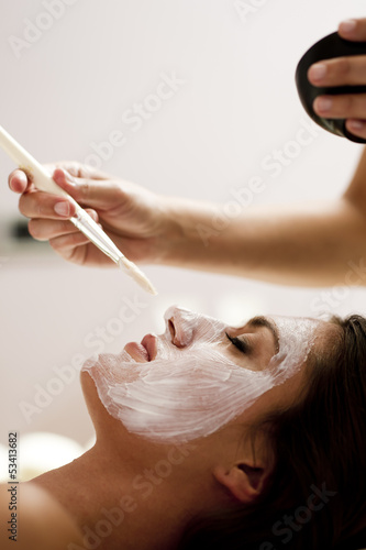 Photo: Young woman getting a facial treatment Young woman getting a facial treatment