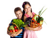 Photo: Smiling kids with vegetables in basket Smiling kids with vegetables in basket