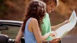 Couple reading map on side of the road