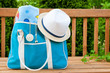 Blue bag with towel and hat for outdoor pool or beach weekend.