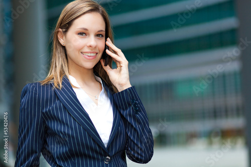 Photo: Beautiful businesswoman at phone Beautiful businesswoman at phone
