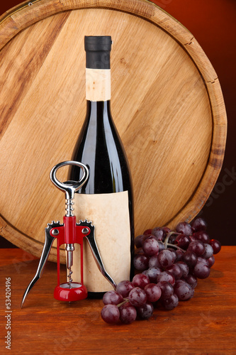 Photo: Composition of corkscrew and bottle of wine, grape, wooden Composition of corkscrew and bottle of wine, grape, wooden
