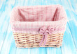 Wicket basket with pink fabric and bow,