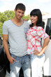Portrait of happy beautiful couple standing near car