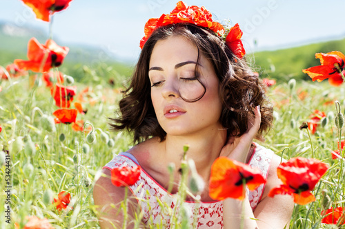 Photo: Young girl in poppies field Young girl in poppies field