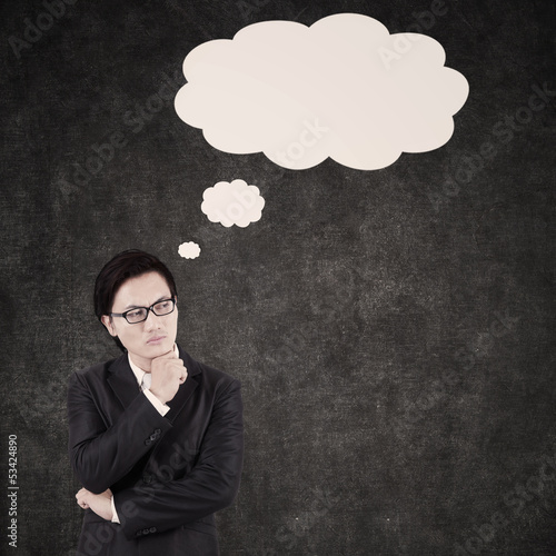 Photo: Thoughtful Asian Businessman shot in studio Thoughtful Asian Businessman shot in studio
