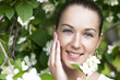Portrait of beautiful brunette in spring blossom