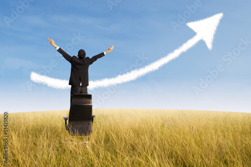 Photo: Happy businessman and growing chart cloud outdoor Happy businessman and growing chart cloud outdoor