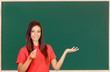 Attractive brunette teacher with a chalk