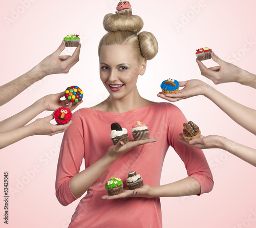 Photo: pretty girl with many colorful cupcakes pretty girl with many colorful cupcakes