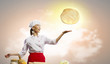 Asian female cook making  pizza