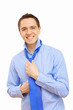 Businessman at home making his tie