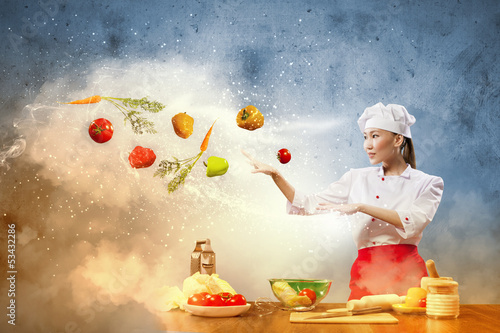Photo: Asian female cooking with magic Asian female cooking with magic