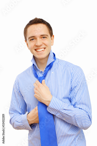 Photo: Businessman at home making his tie Businessman at home making his tie