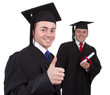 Two graduates with the first showing a thumbs up sign and the se