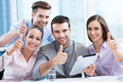 Photo: Business team with thumbs up Business team with thumbs up