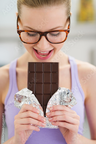 Photo: Teenage girl eating chocolate bar Teenage girl eating chocolate bar