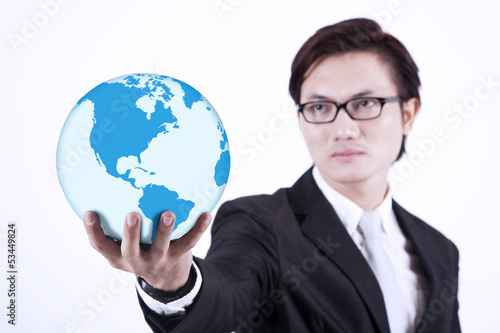 Photo: Businessman giving world globe on white Businessman giving world globe on white