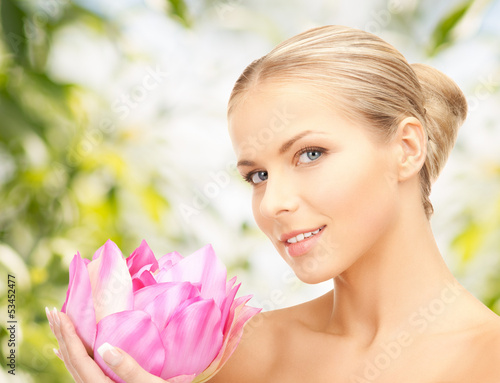 Photo: beautiful woman with lotus flower beautiful woman with lotus flower