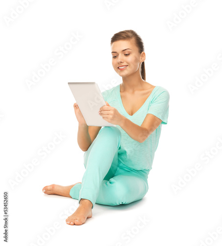 Photo: girl sitting on the floor with tablet pc girl sitting on the floor with tablet pc