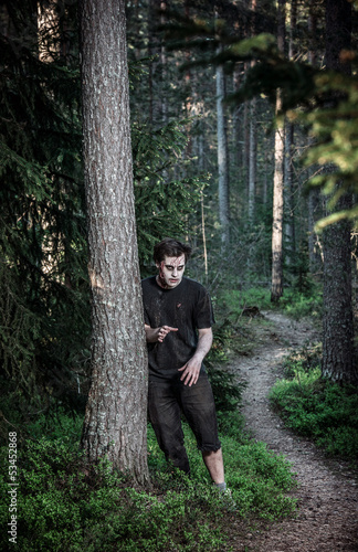 Photo: a scary and bloody zombie man a scary and bloody zombie man