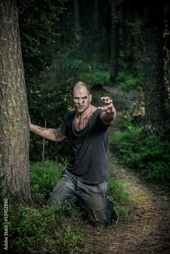 Photo: a scary and bloody zombie man a scary and bloody zombie man