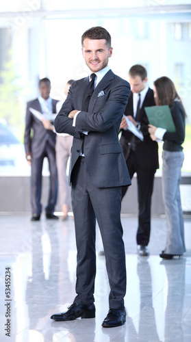 Photo: Happy smart business man with team mates discussing Happy smart business man with team mates discussing