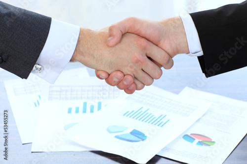Photo: Business handshake and business people Business handshake and business people