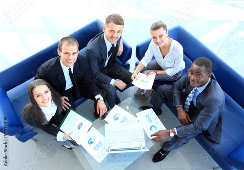Photo: Top view of working business group sitting at corporate meeting Top view of working business group sitting at corporate meeting