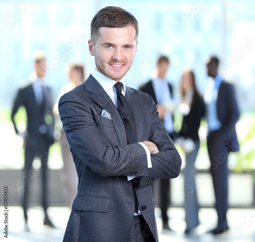 Photo: Happy smart business man with team mates discussing Happy smart business man with team mates discussing