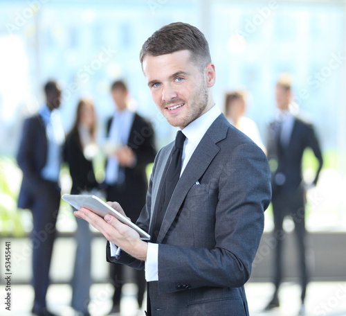 Photo: Business man touching digital tablet with business diagram Business man touching digital tablet with business diagram