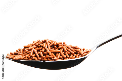 Photo: Brown chocolate sprinkles in a spoon Brown chocolate sprinkles in a spoon