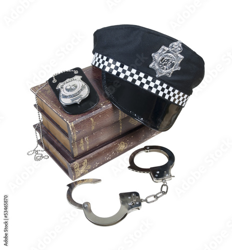 Photo: Police and Crime Books with Police Hat, Badge and Handcuffs Police and Crime Books with Police Hat, Badge and Handcuffs