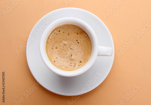 Photo: Cup of coffee on beige background Cup of coffee on beige background