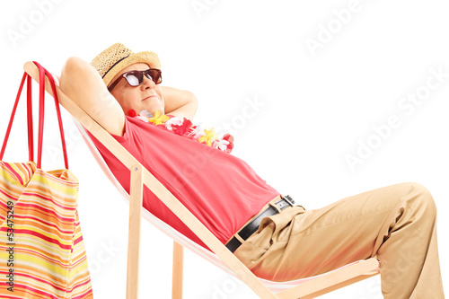 Photo: Mature male tourist enjoying on a beach chair Mature male tourist enjoying on a beach chair