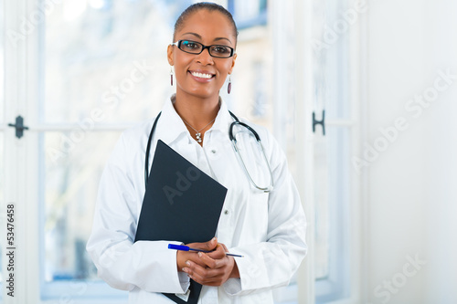 Photo: Portrait of young female doctor in clinic Portrait of young female doctor in clinic