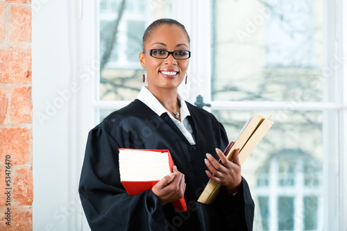 Photo: Lawyer in office with law book and Dossier Lawyer in office with law book and Dossier