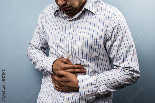 Photo: Multi racial man with constipation Multi racial man with constipation