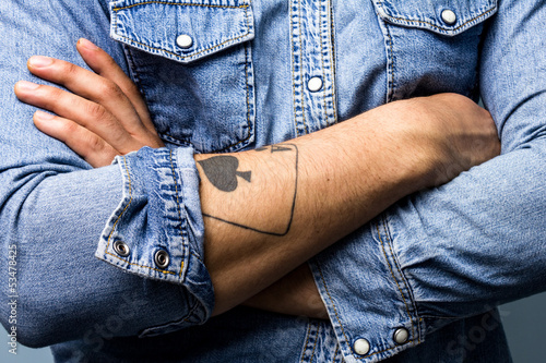 Photo: Ace up his sleeve. Man with an ace of spades tattoo on his arm Ace up his sleeve. Man with an ace of spades tattoo on his arm