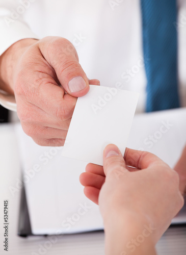 Photo: Two Business People Exchanging Card Two Business People Exchanging Card