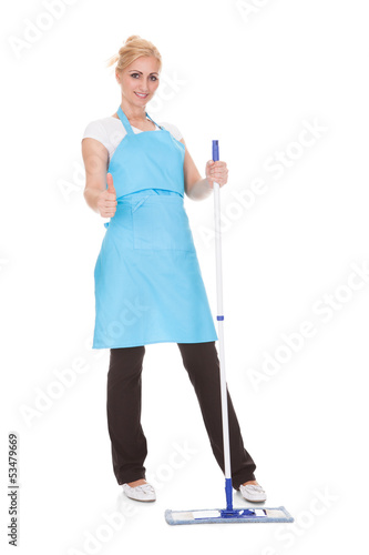 Photo: Portrait Of Woman Holding Broom Portrait Of Woman Holding Broom