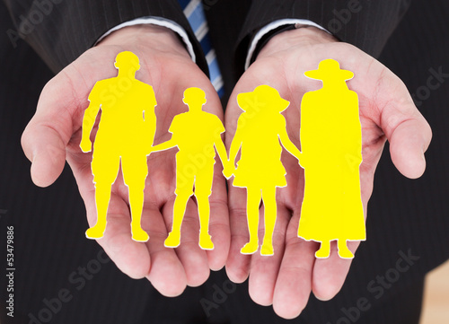 Photo: Male Hand Holding Family Cutout Shape Male Hand Holding Family Cutout Shape