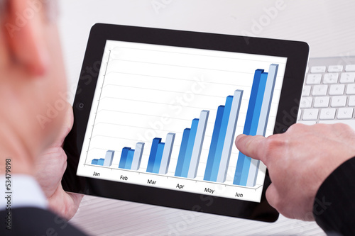 Photo: Businessman Holding Digital Tablet Businessman Holding Digital Tablet