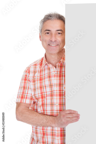 Photo: Happy Mature Man Holding Blank Placard Happy Mature Man Holding Blank Placard